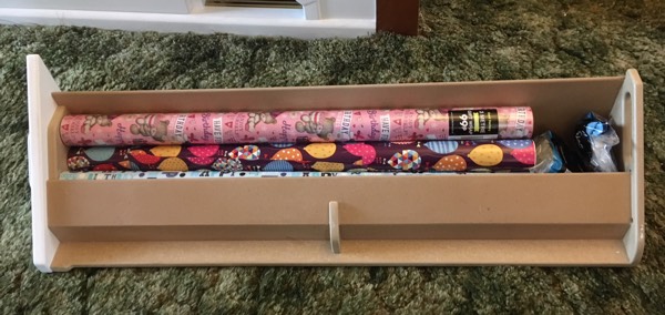 wrapping paper caddy with rolls of wrapping paper and cellotape in it